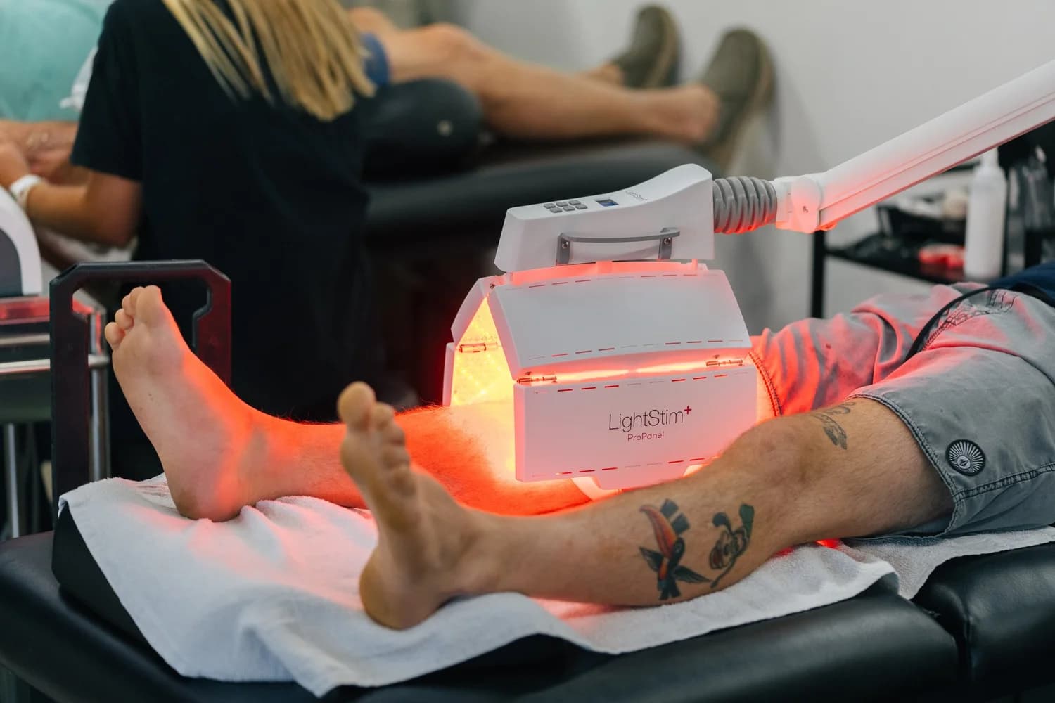 Red light therapy panel treating a patient at Range Sports Therapy