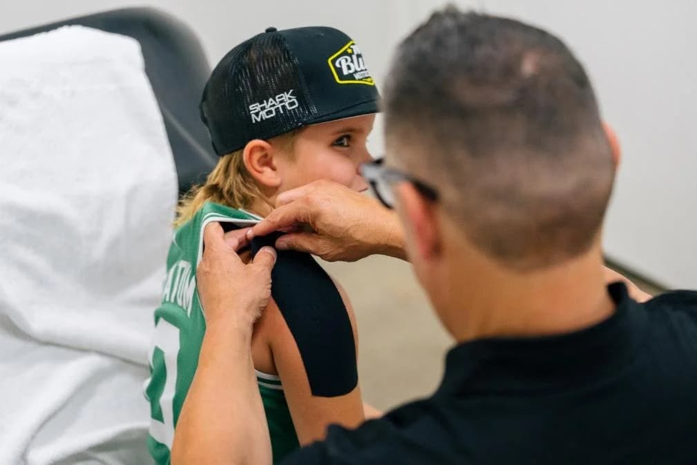 Taping a young athlete before competition
